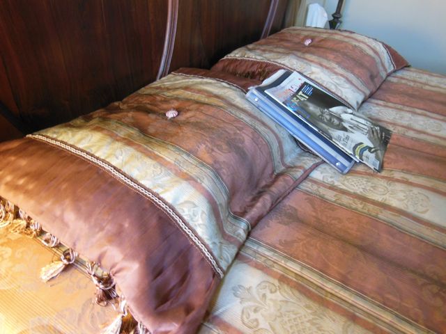 Beautifully made bed in NOLA.  I still threw the coverlet on the floor. Image from Ann Santori.