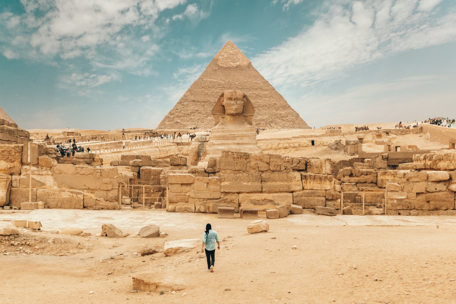 tourist walking toward the pyramids - budget travel tips from Wanderful